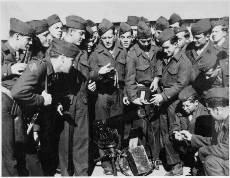 Sgt. Basilone receives the congratulations of his platoon.