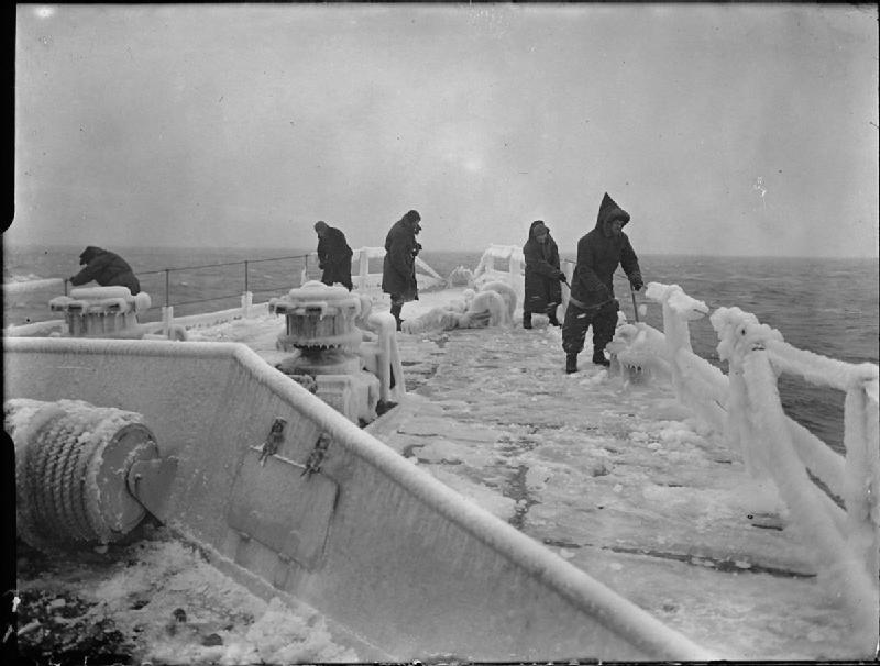 Members of the crew clearing the frozen focsle of HMS INGLEFIELD during convoy duty in Arctic waters.