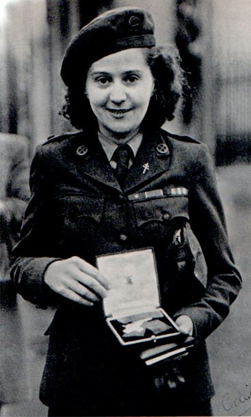 Odette Sansom holding her medals.