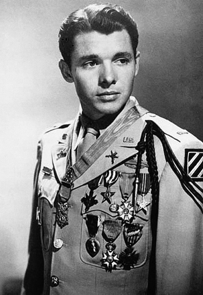 Audie Murphy photographed in 1948 wearing the U.S. Army khaki "Class A" (tropical service) uniform with full-size medals. Source: Wikipedia.
