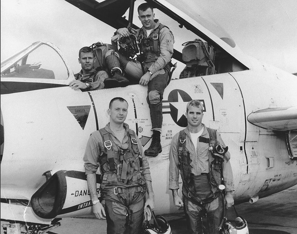 Lieutenant McCain (front right) with his squadron and T-2 Buckeye trainer, 1965