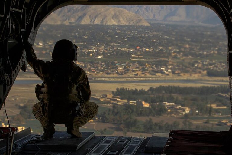 A U.S. Army crew chief with 17th Cavalry Regiment surveys the area over Jalalabad, Afghanistan.