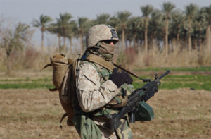 Armed with a Squad Automatic Weapon and cold weather gear, Lance Cpl. William English, machine gunner, 1st Platoon, Company B, 1st Battalion, 23rd Marine Regiment, and a 23-year-old native of Houston, takes part in a security patrol around Ramadi, Iraq, Dec. 27.