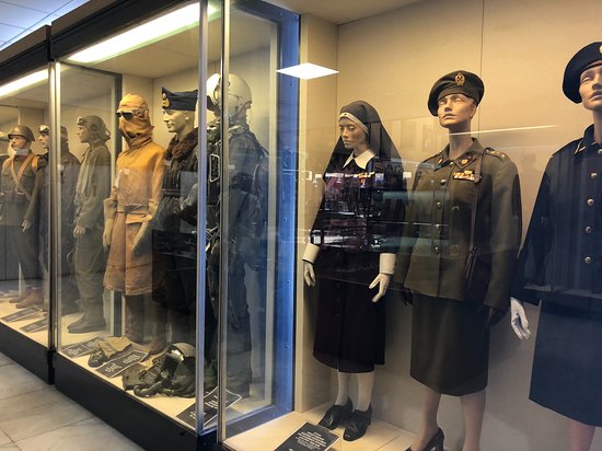 Uniforms on display (male and female) through the entrance of the museum.