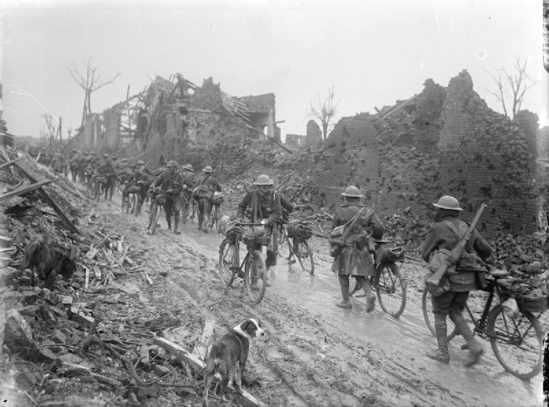 British cyclist troops advance through Brie, Somme, 1917.
