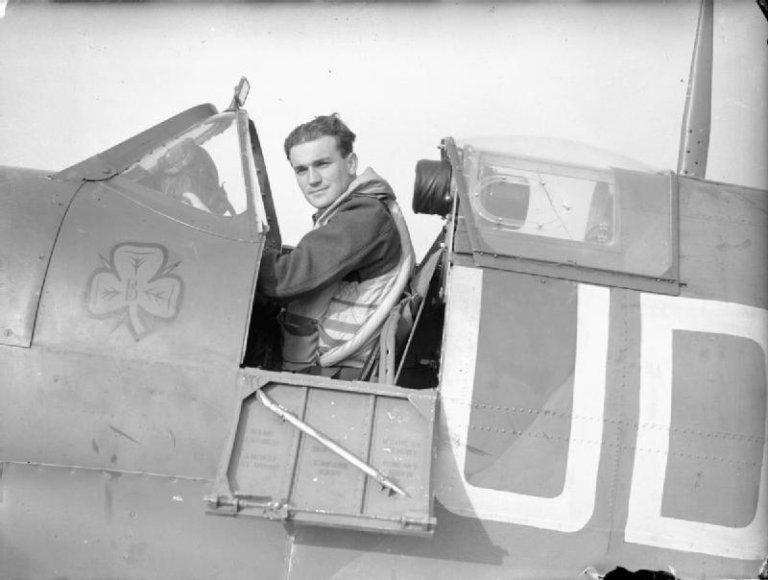 Flight Lieutenant Brendan 'Paddy' Finucane DFC seated in the cockpit of his Supermarine Spitfire.