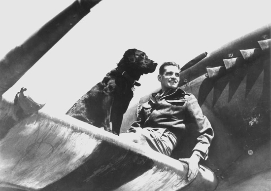 Johhnnie Johnson, relaxing in between sorties on the wing of his Spitfire in Normandy, c.June–August 1944.