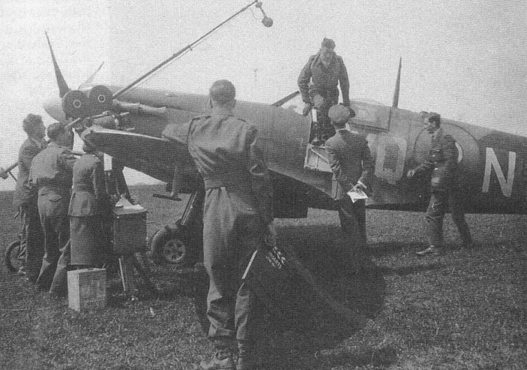 Johnson climbing out of the cockpit of his Spitfire. Kings Cliffe 1941.